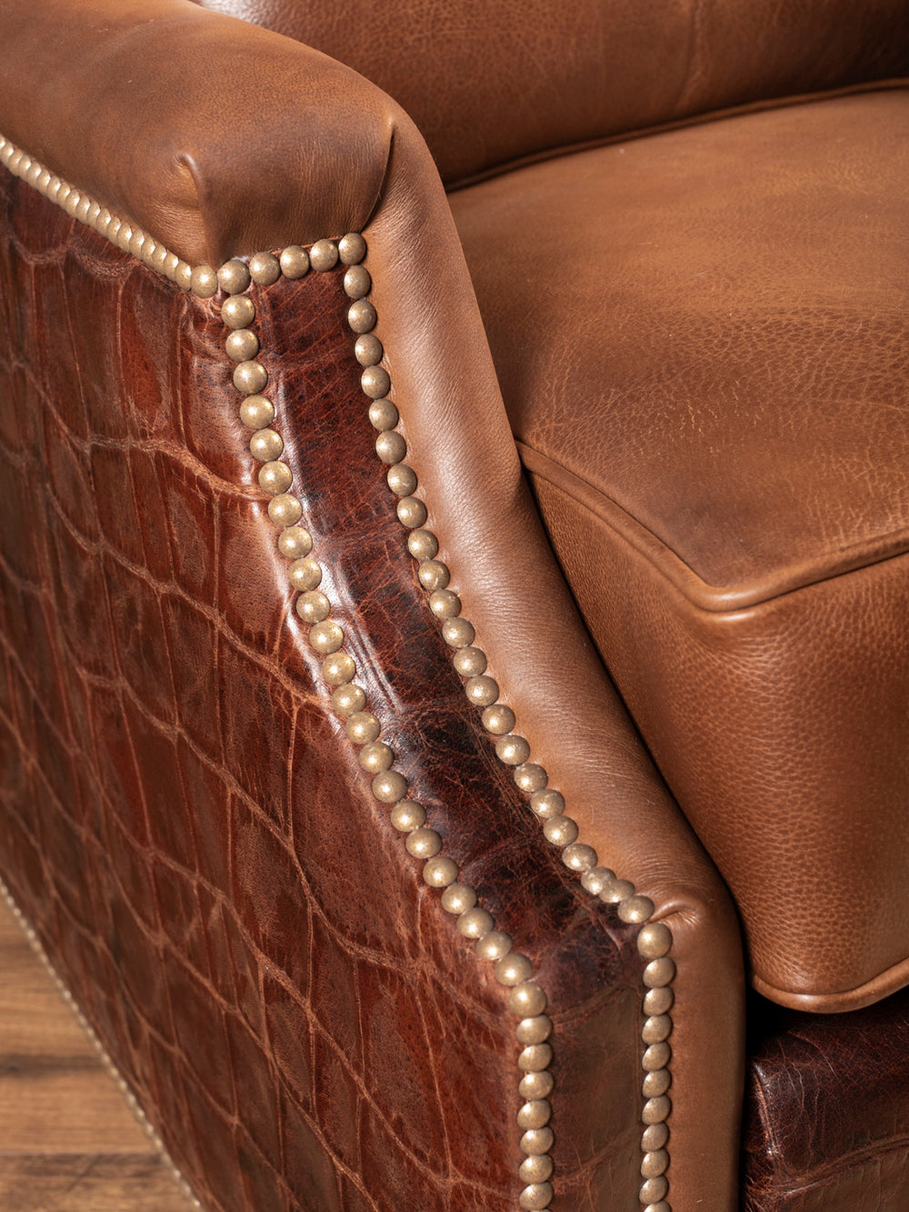 Side arm view with almond leather and brass nailhead detail