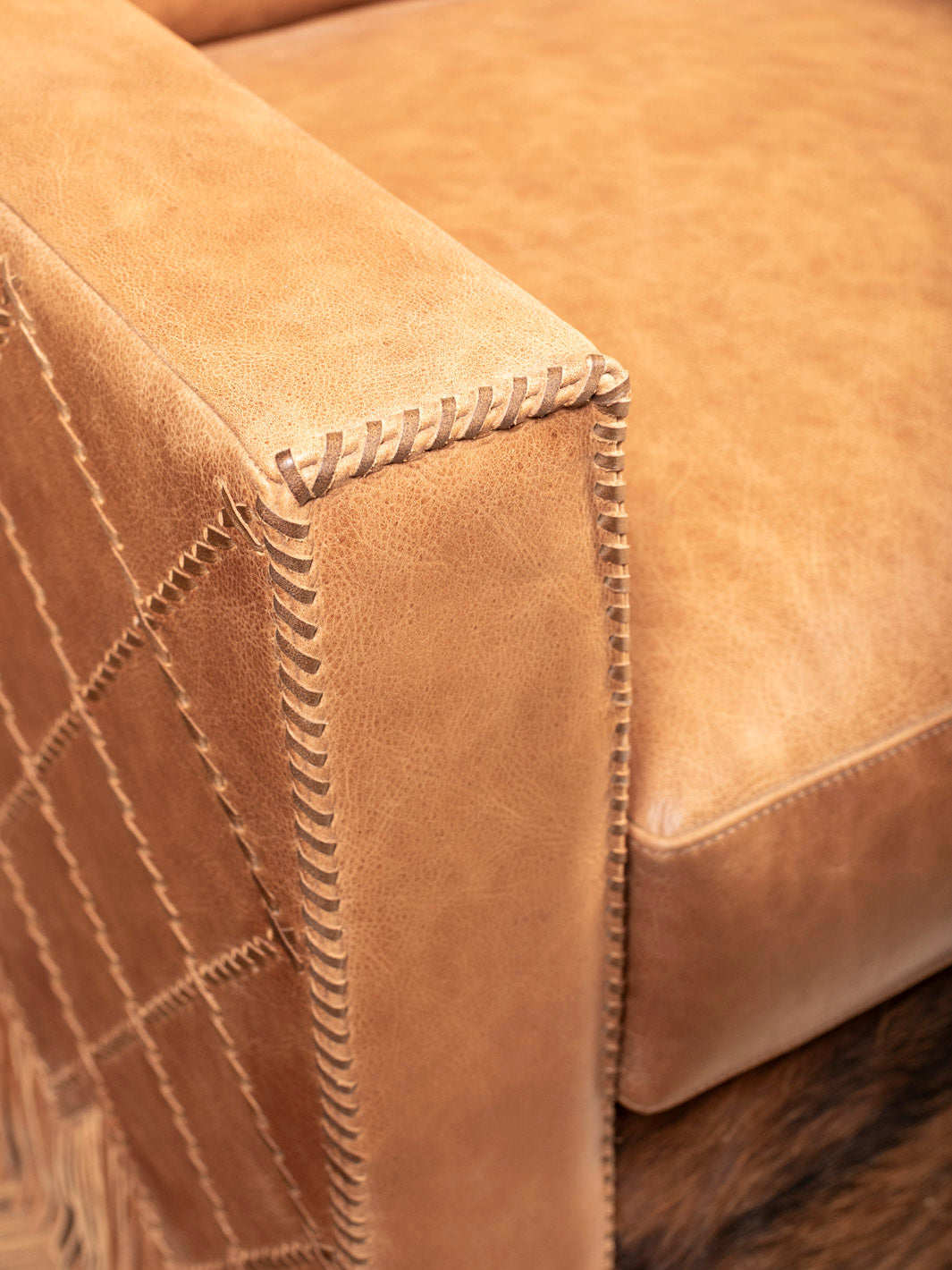 Detail view of hand-laced seams and full-grain leather on Belmont Laced Chair