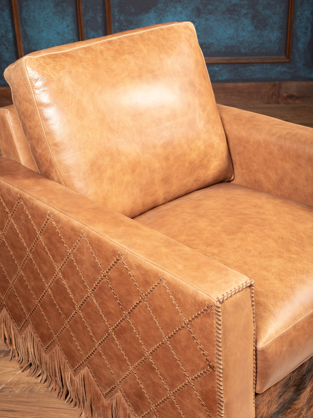 Seat and arm detail of Belmont Laced Leather Swivel Chair in natural tan leather