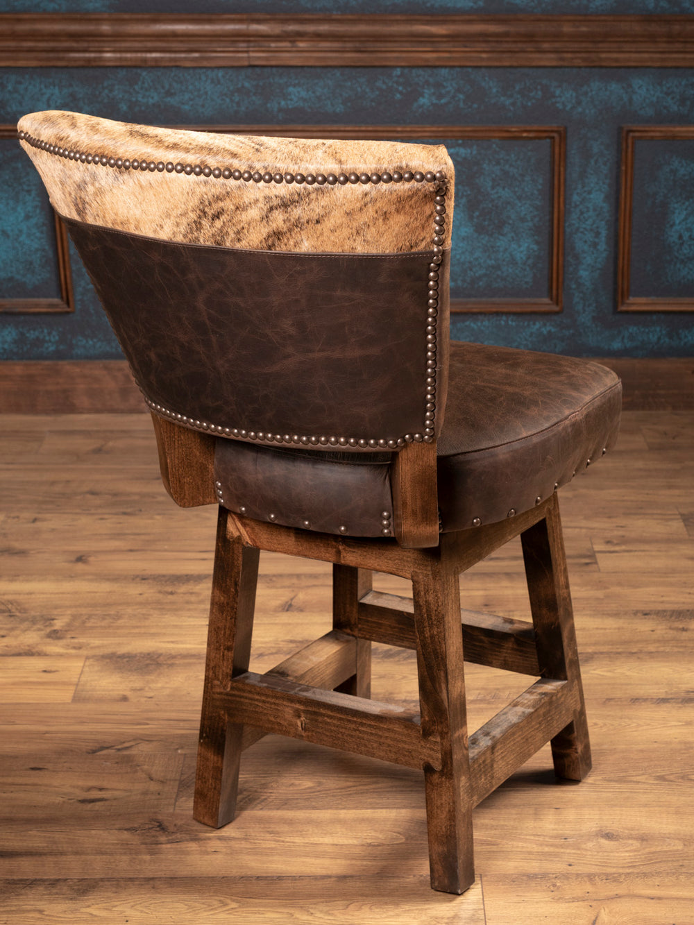 Back View Detail: Back of bar stool featuring cowhide panel framed with decorative nailhead trim