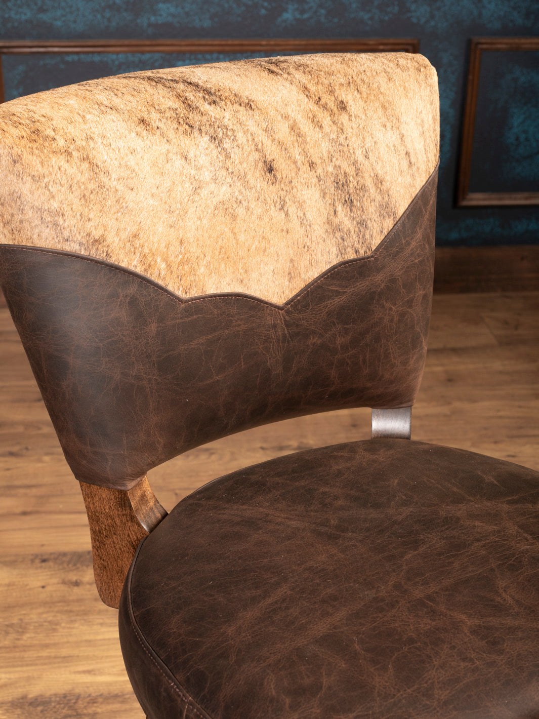 Top Back Detail: Speckled cowhide and distressed leather backrest with Western scalloped edge design