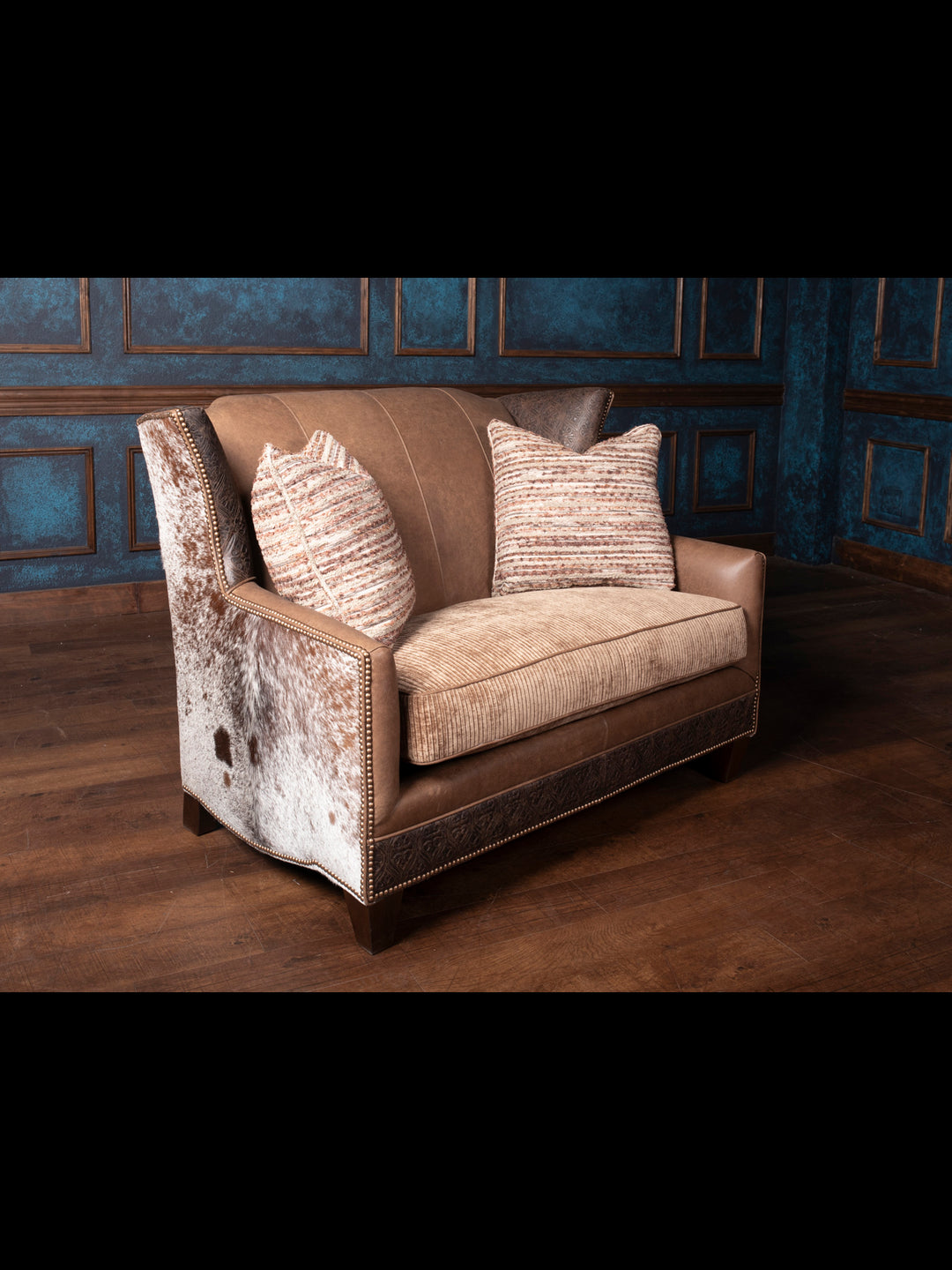 Front view of the Hazelnut Leather Settee featuring premium Rustler leather and unique hair-on-hide accents, offering a rustic yet refined design