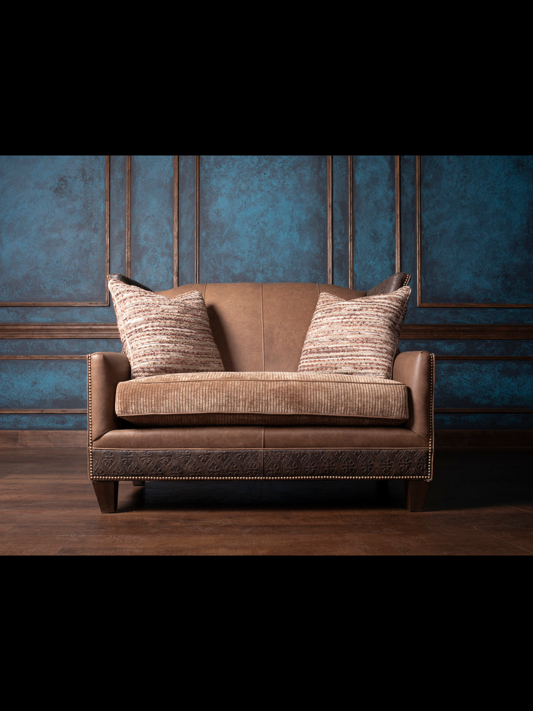Front view Hazelnut Leather Settee showcasing premium full-grain Rustler leather in a rich Hazelnut color, with unique hair-on-hide accents and a solid wood frame