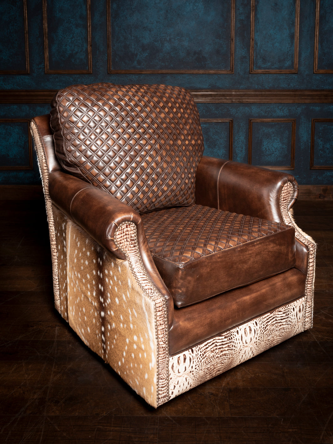 A brown leather swivel chair with a diamond stitch pattern and crocodile embossed accents, set against a blue panelled wall.