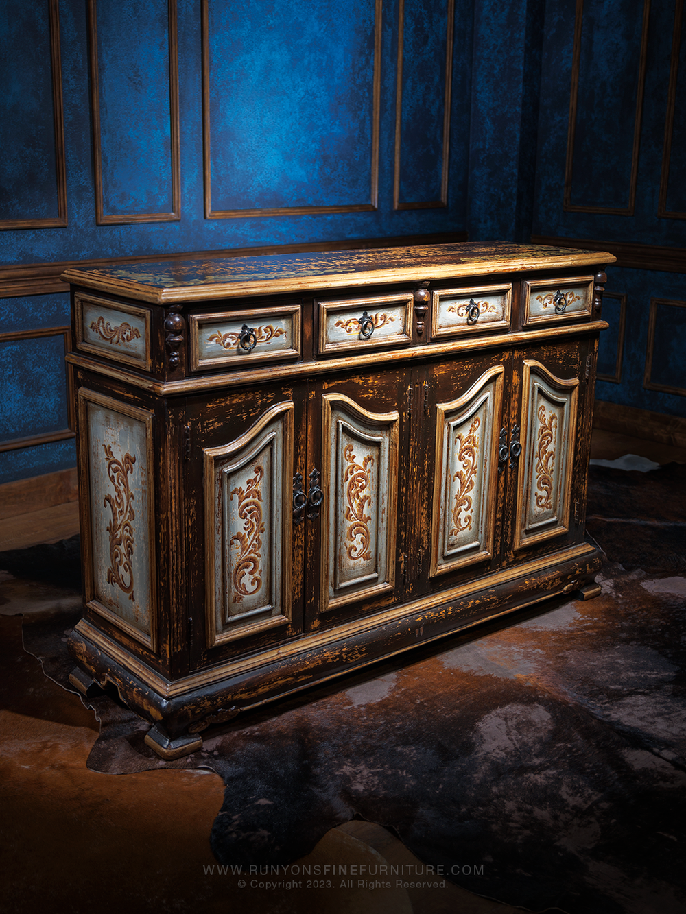 A distressed Old World-style buffet with intricate carved details on the drawers and doors, featuring antique-style hardware and a worn finish.