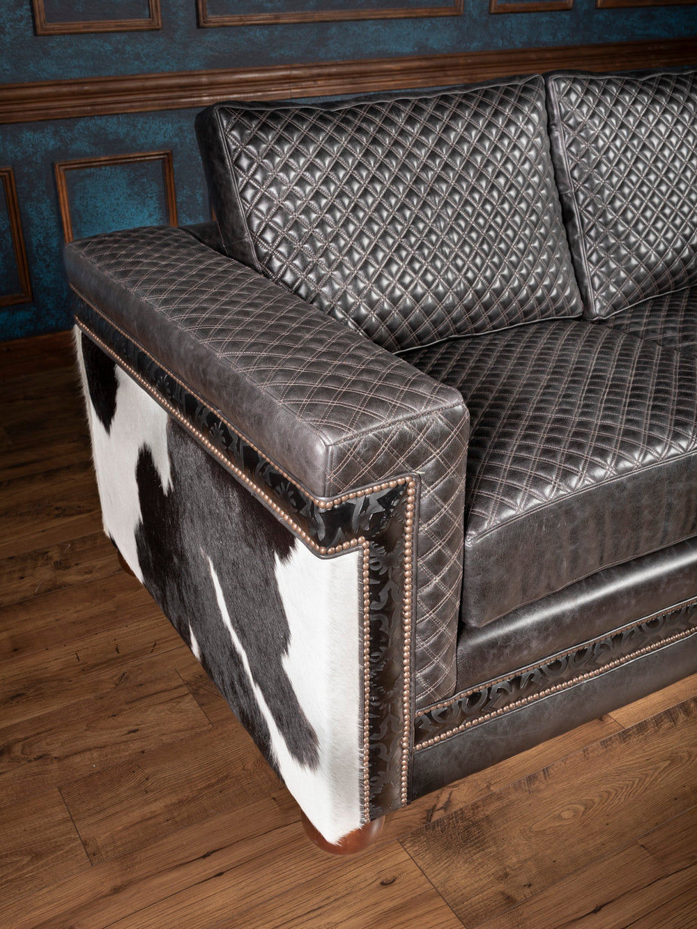 Close-up of black and white cowhide arm panel, quilted arm and cushions