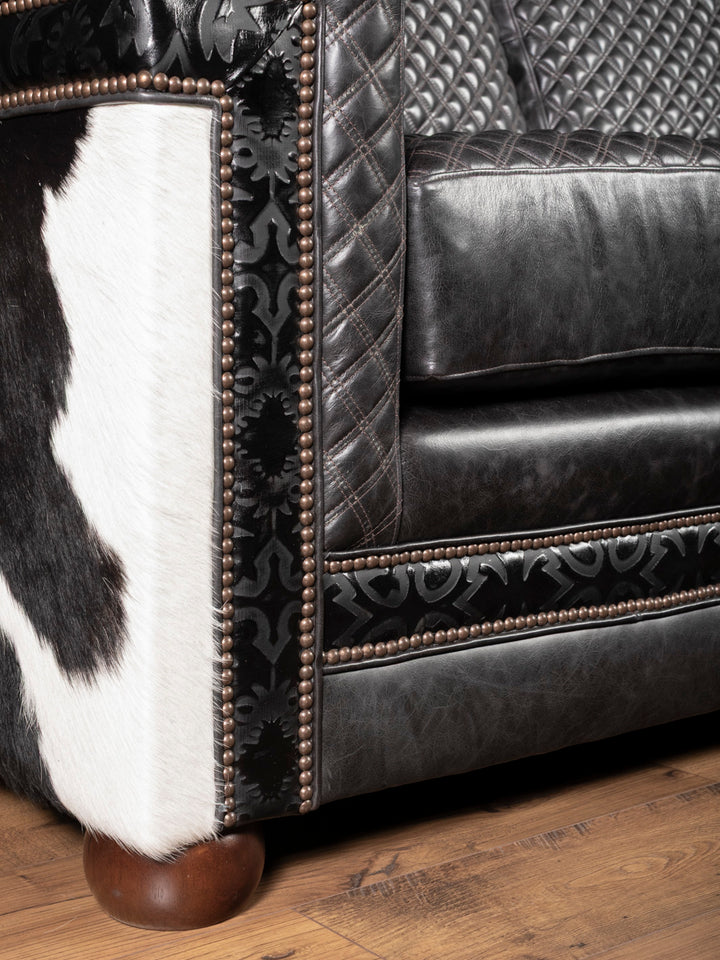 Rounded wood leg and lower sofa edge with trim accents