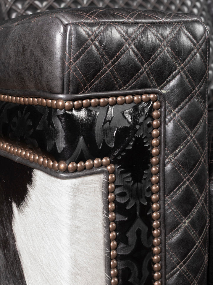 Detailed view of quilted armrest and embossed leather trim