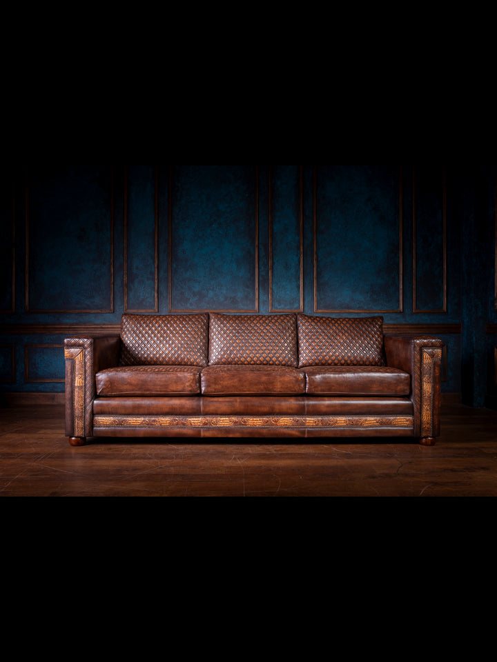 Western-style architect sofa featuring diamond-quilted leather back cushions and embossed leather accents on the base and arms, all in a rich chocolate brown finish