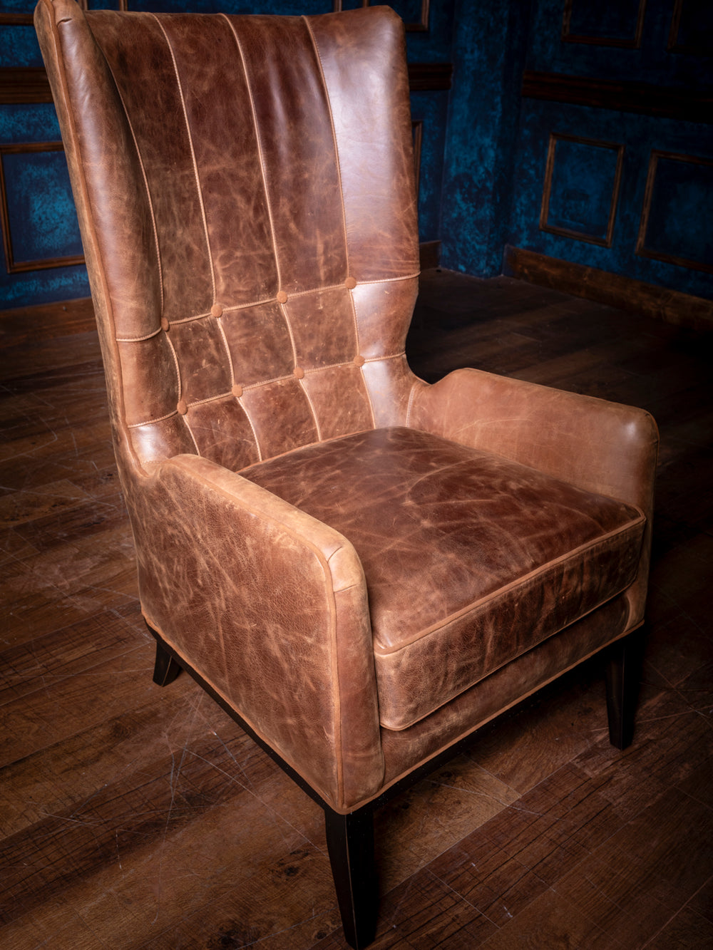 Close-up of the quilted stitching and buttons on the backrest of the Rustic Sycamore Leather Accent Chair, showcasing intricate craftsmanship and attention to detail