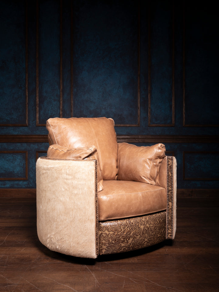 A brown leather swivel recliner chair with floral embossed details, positioned against a blue panelled wall.