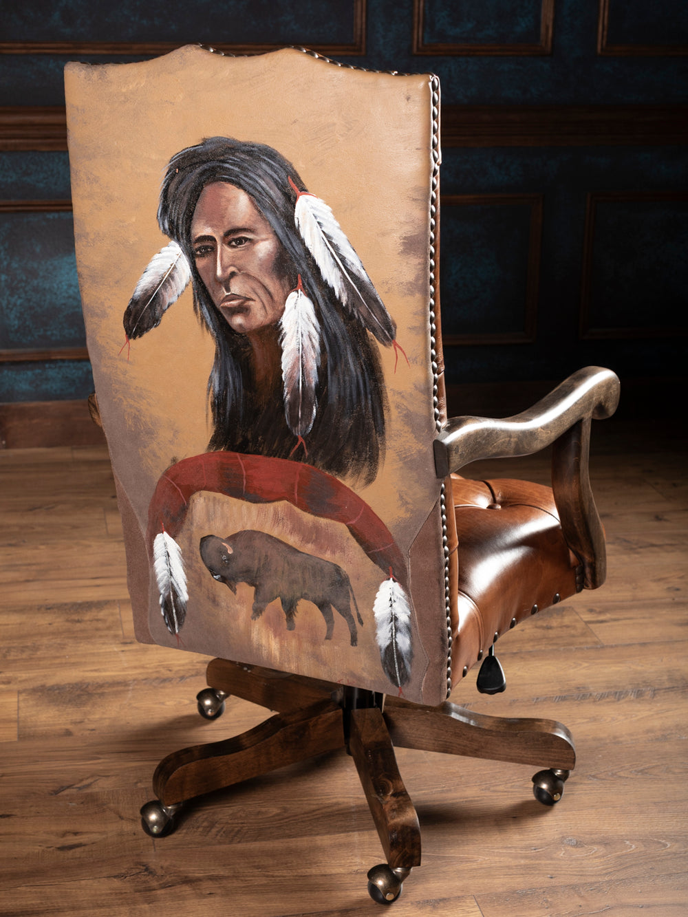 Chair with a backrest featuring a Native American design on a wooden floor.