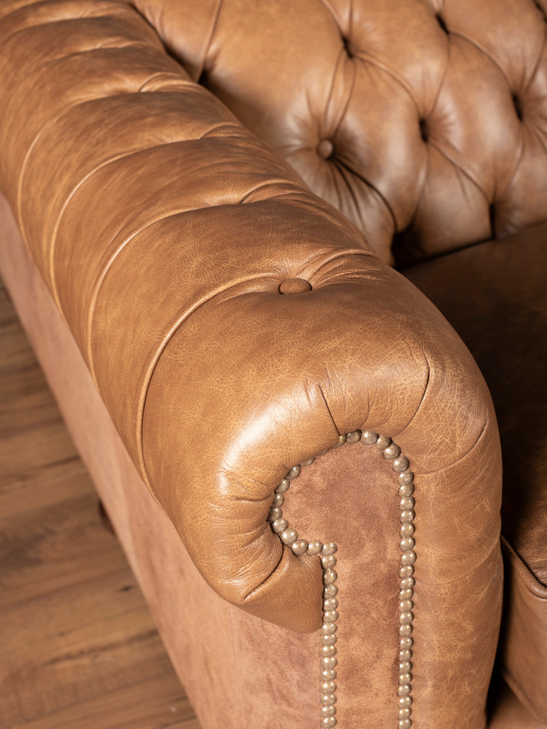 Detail of rolled arm with nailhead trim