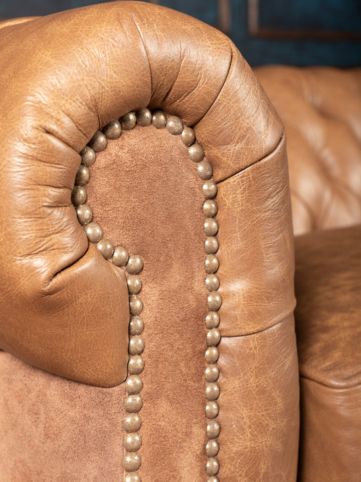 Close-up of nailhead detail on suede front arm