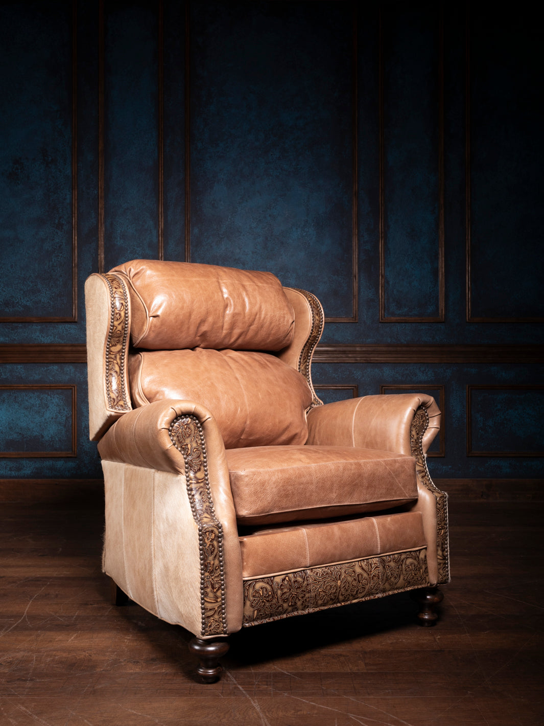 A brown leather recliner chair with sunflower embossing and hair-on-hide accents, set against a blue panelled background.