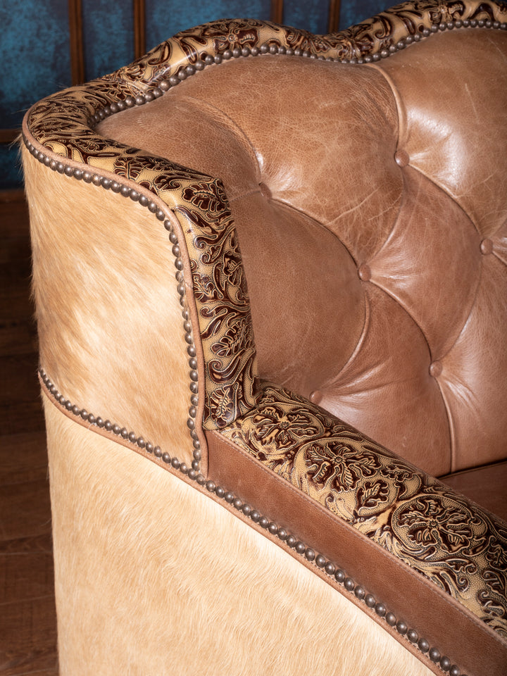 Detailed view of tooled leather armrest on a Western Sunflower Utah sofa, highlighting floral embossing and craftsmanship.