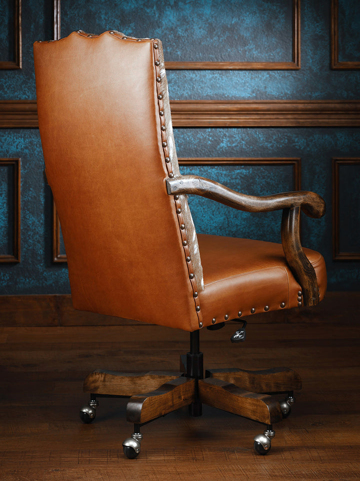 Whiskey Axis Hide Desk Chair with leather upholstery, visible armrests, set against a plain backdrop, showcasing a sleek, rustic design for comfort and style.