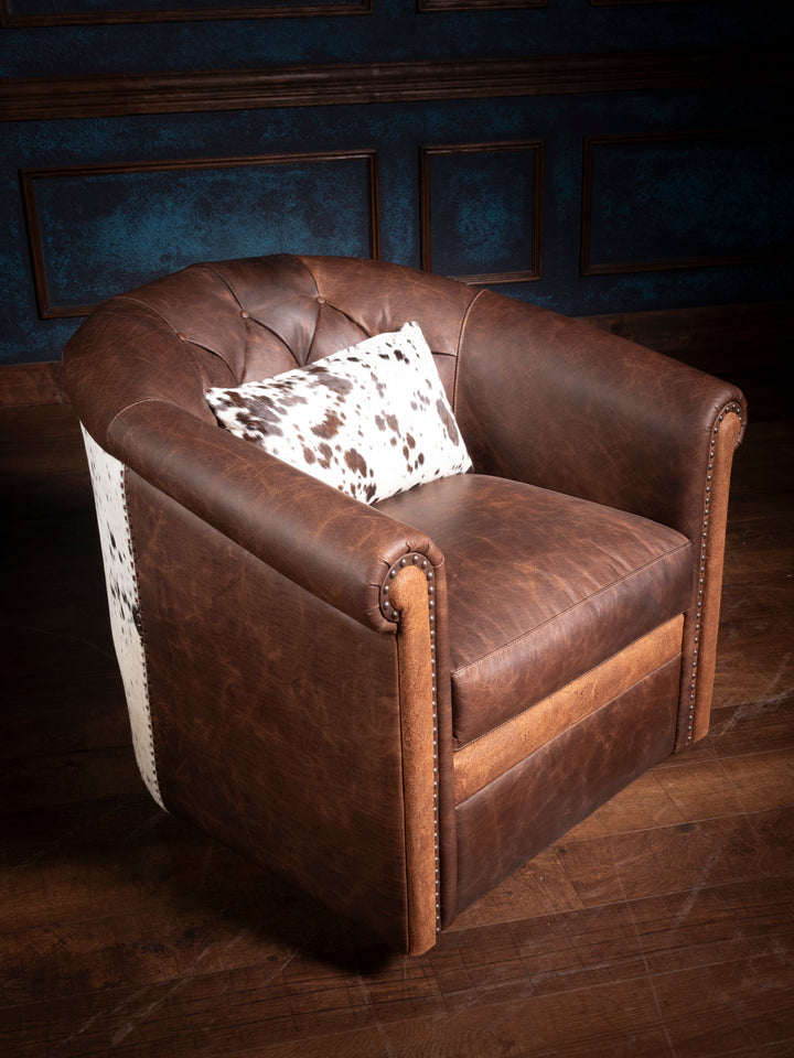 Bison Ridge leather chair with classic tufted upholstery and elegant nailhead trim, set in a luxurious panelled room.