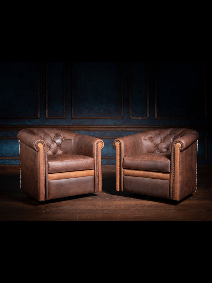 Two Bison Ridge leather chairs in a refined setting with dark blue wall paneling, highlighting their luxurious design and craftsmanship.