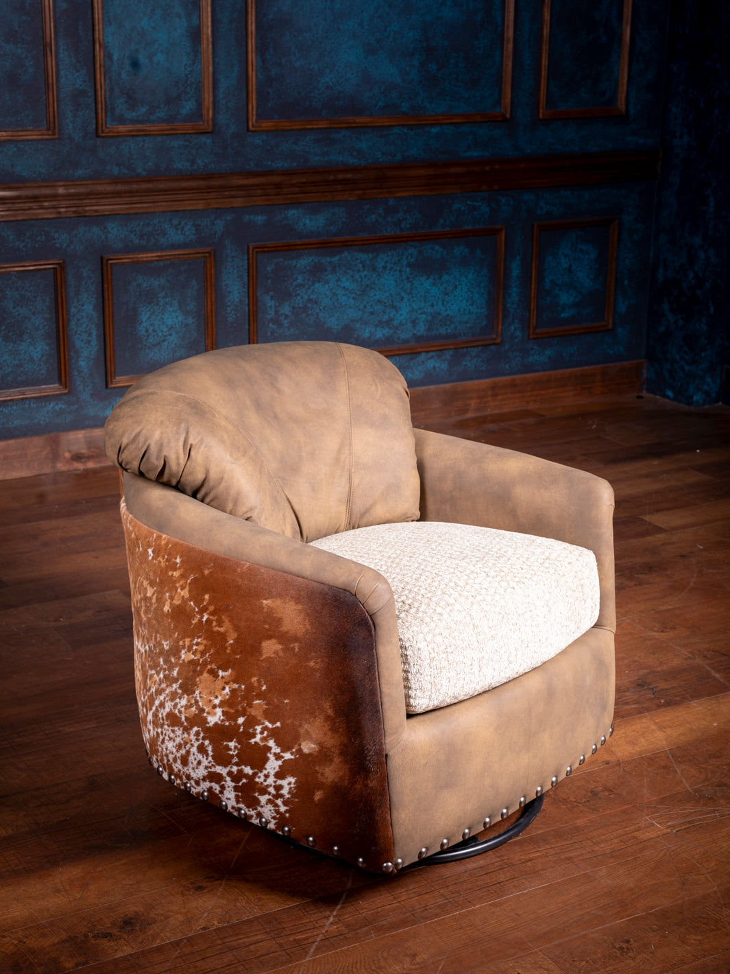 A brown leather swivel chair with visible wear and tear, placed in a room with blue paneling.