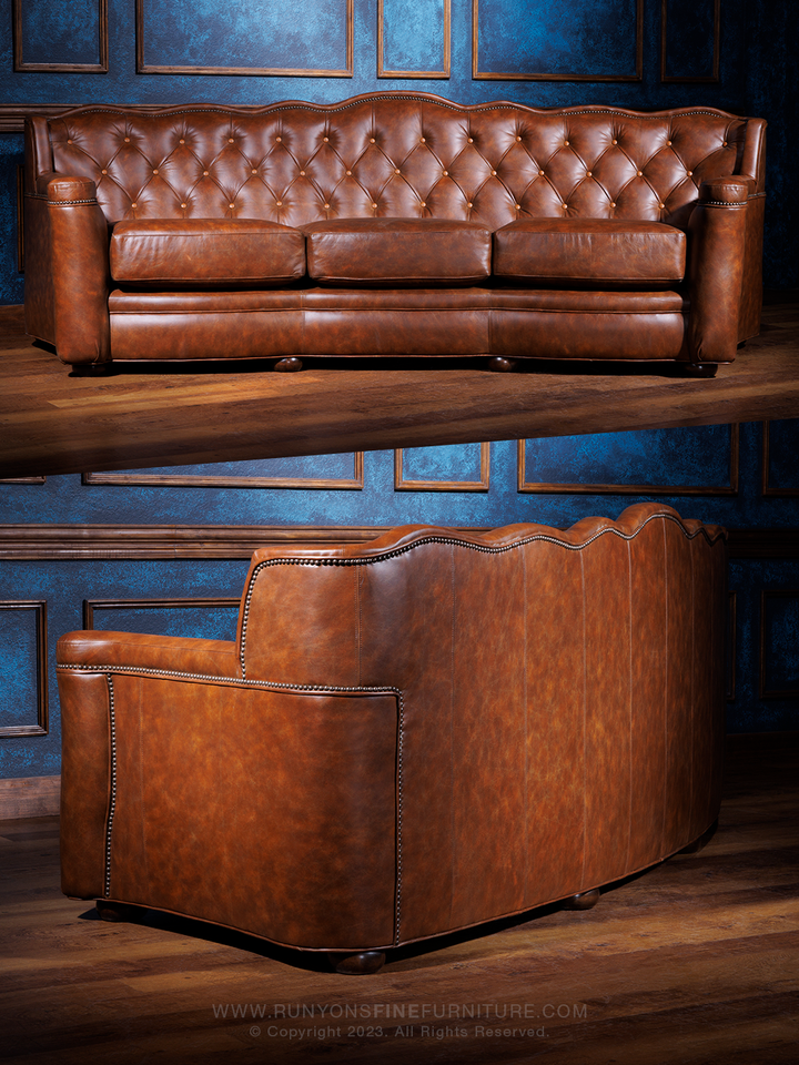 A hazelnut brown leather sofa with tufted buttons, displayed in a room with blue walls.