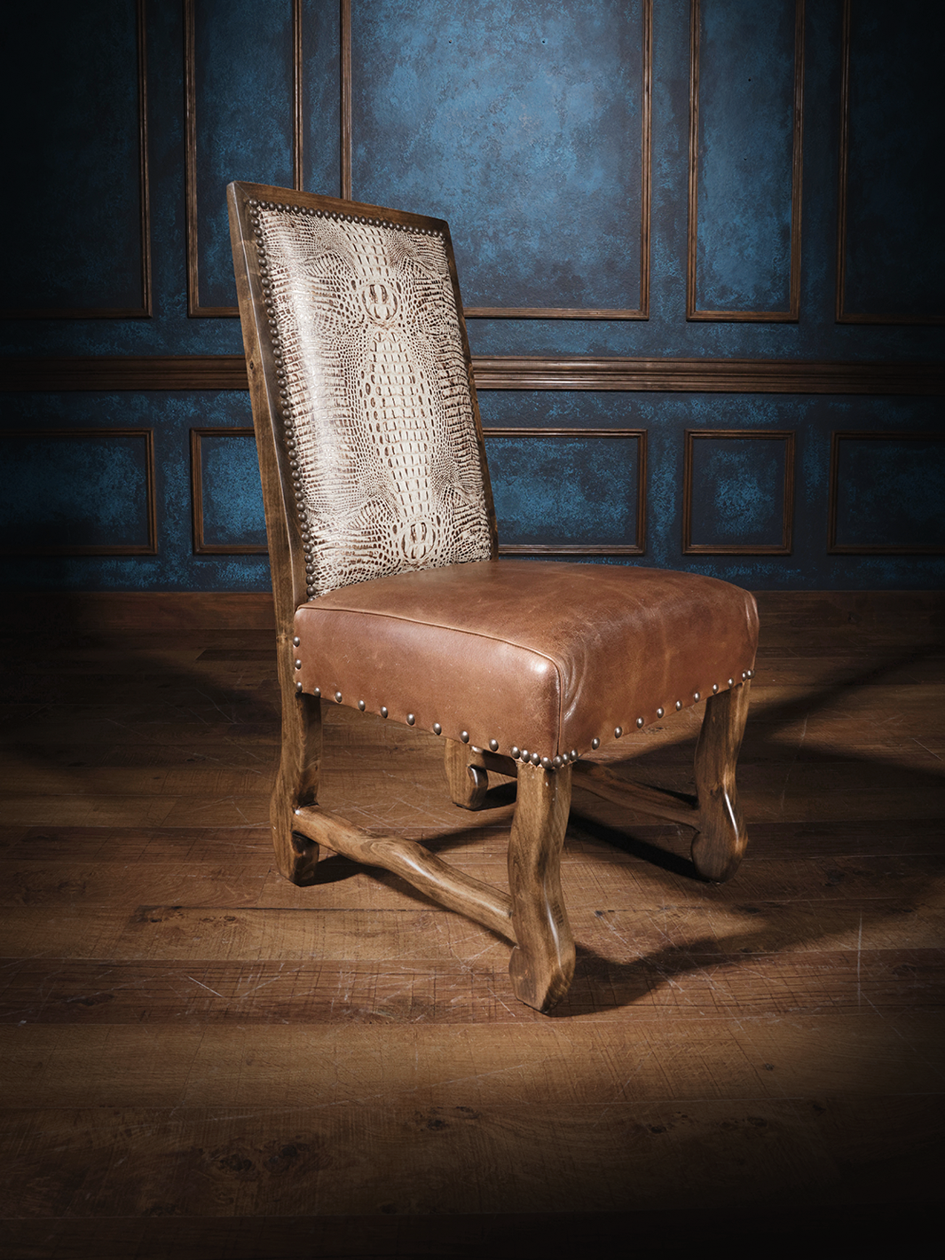 A brown leather dining chair with a flat top design and crocodile pattern embossing, featuring a Cambridge rum leather seat.