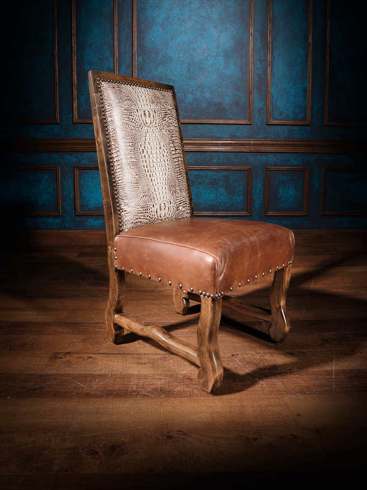 A brown leather dining chair with a flat top design and crocodile pattern embossing, featuring a Cambridge rum leather seat.
