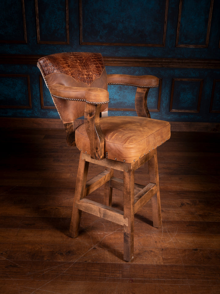 A brown leather bar stool with wooden frame and axis hide accents, displayed in a dimly lit room.