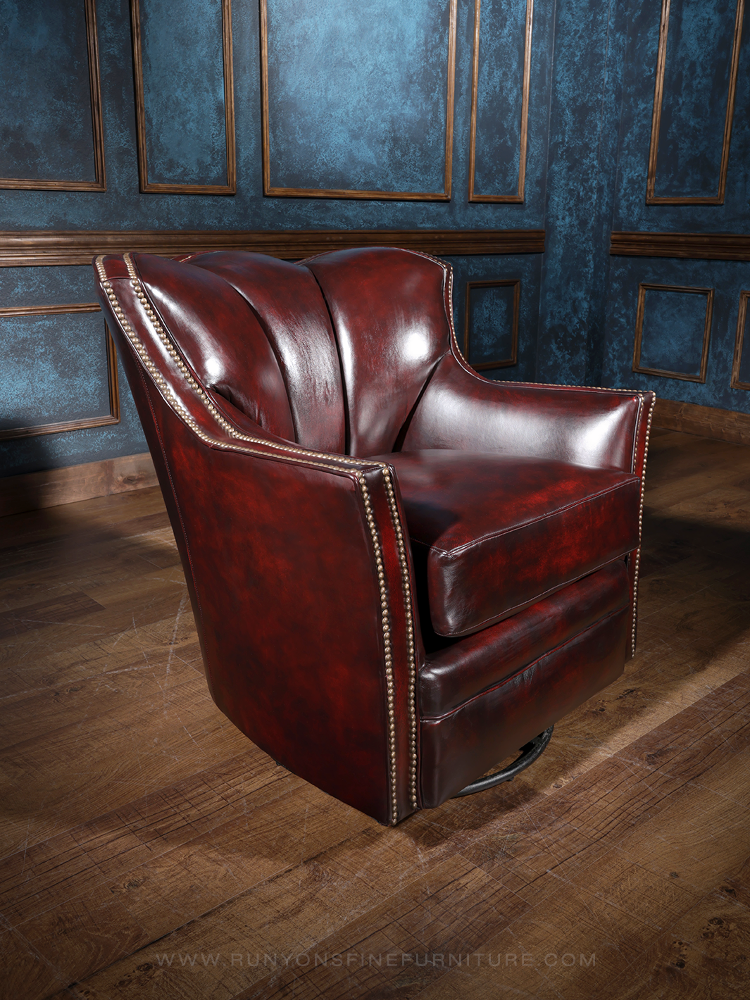A red leather swivel chair with a classic design, featuring a high backrest and a round, padded seat. The chair is positioned in a room with a dark, textured wall in the background.