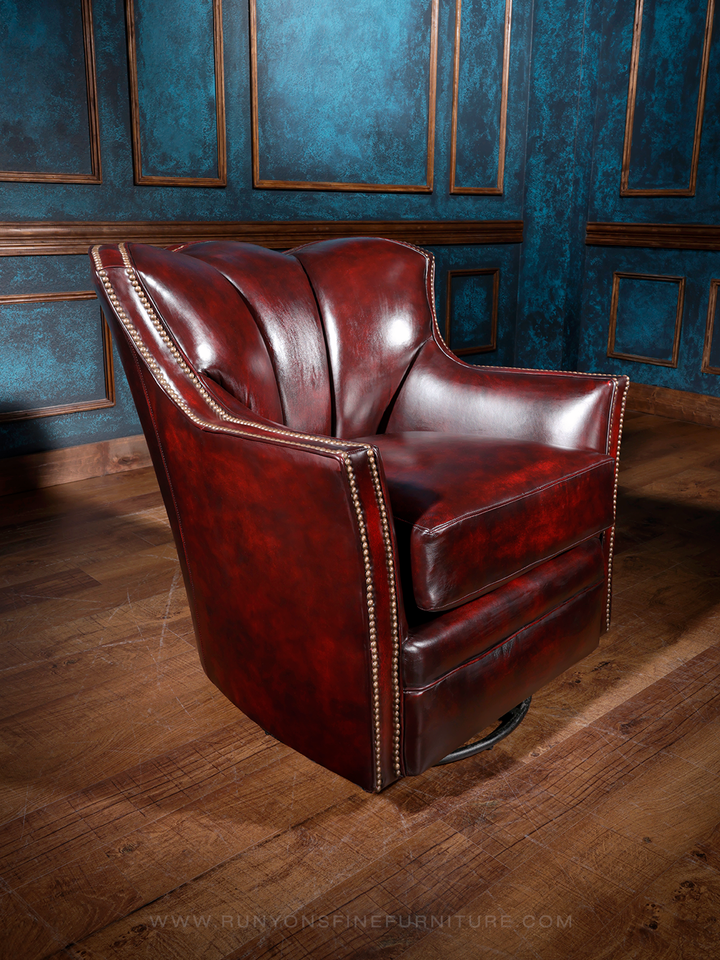 A red leather swivel chair with a classic design, featuring a high backrest and a round, padded seat. The chair is positioned in a room with a dark, textured wall in the background.