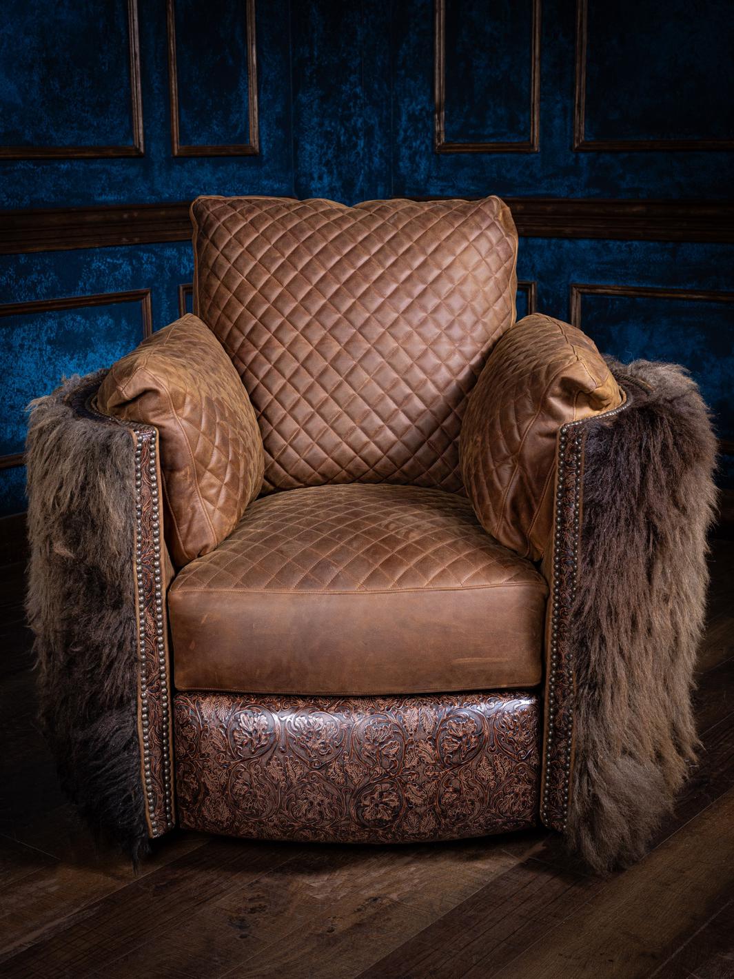 A brown leather swivel recliner chair with quilted backrest and buffalo hair on hide accents on the arms, set against a blue panelled wall.