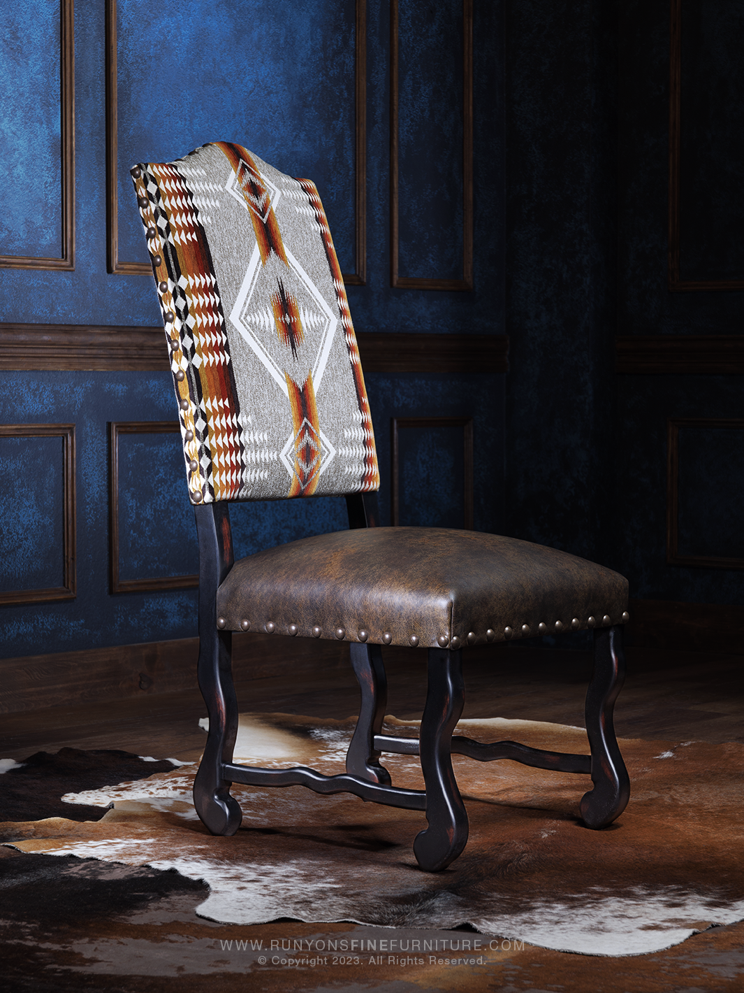 A Southwestern style dining chair with a geometric pattern on the backrest, genuine leather seat, and antique black frame.