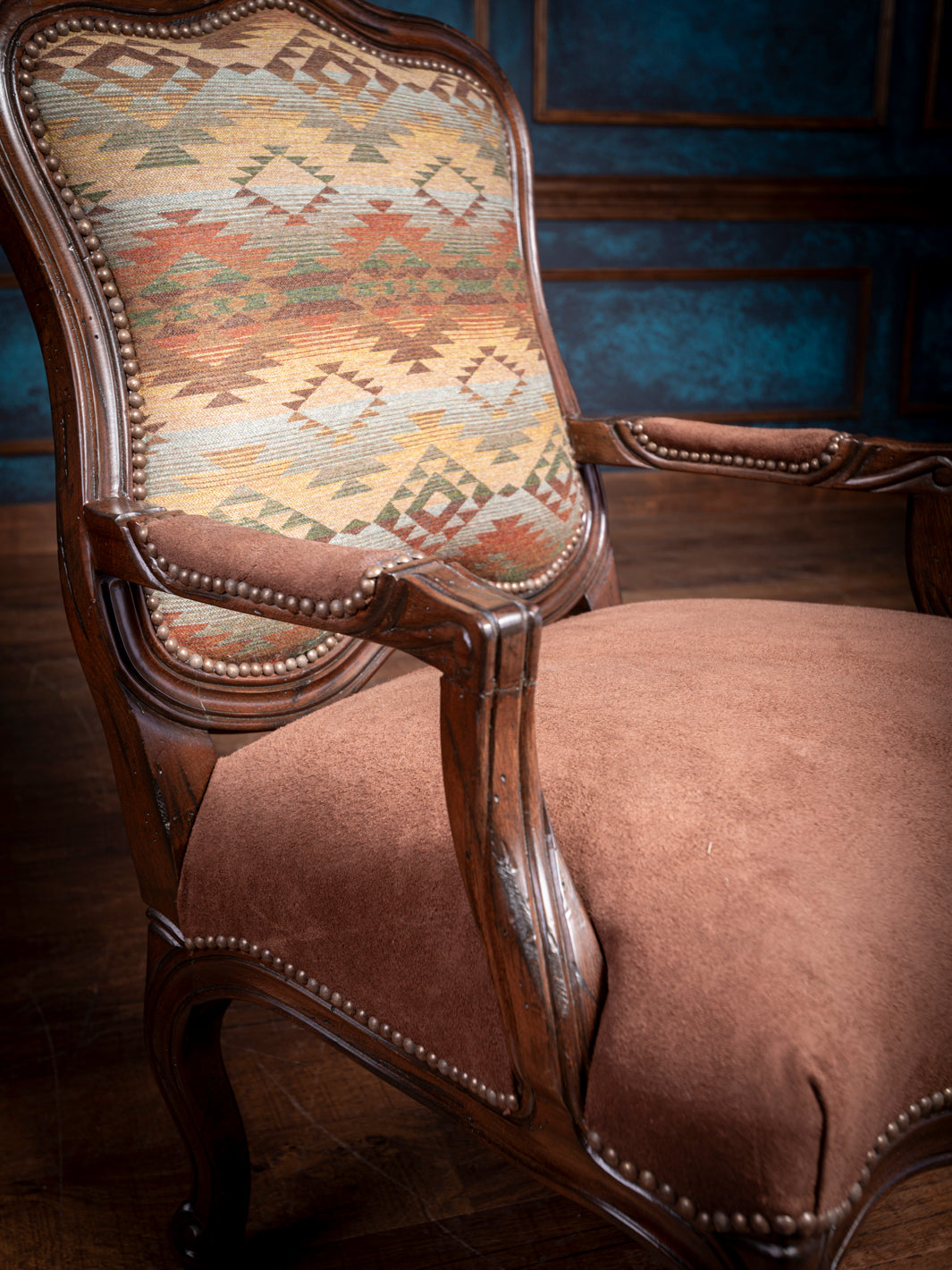 Detailed view of the Southwestern-patterned fabric backrest on the Southwestern Heritage Carved Chair, adding vibrant color and texture
