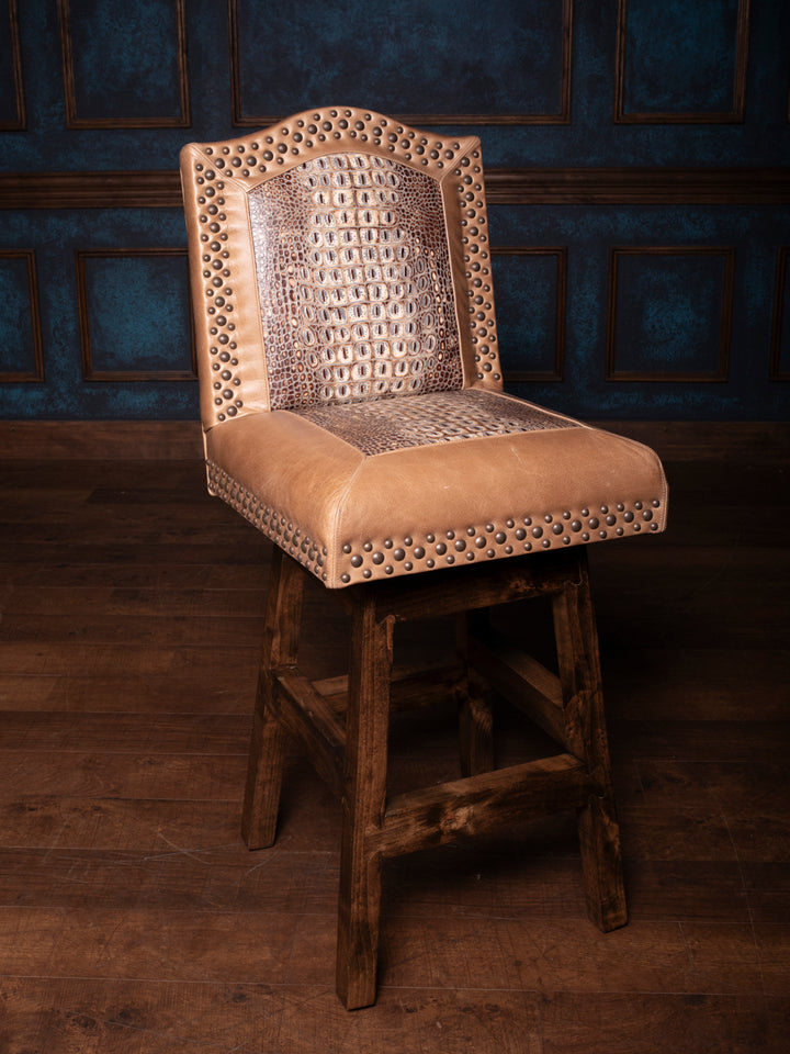A brown leather bar stool with a floral pattern on the backrest, upholstered on a wooden stool base.