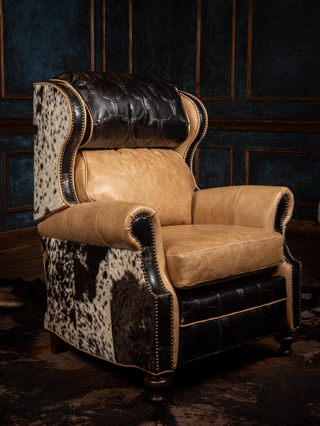 A tan longhorn embossed leather recliner chair with black accents and detailed stitching.