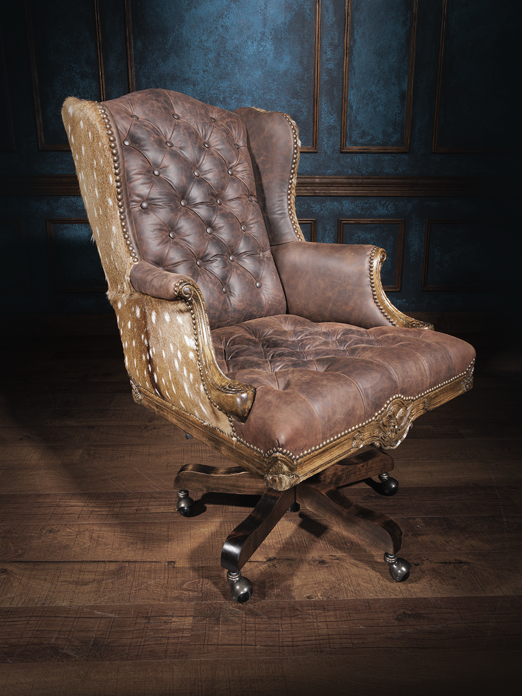 Tufted leather office chair with a high backrest, brown leather upholstery, button tufting, axis hide accents, nailhead trim, and a swivel base with casters.