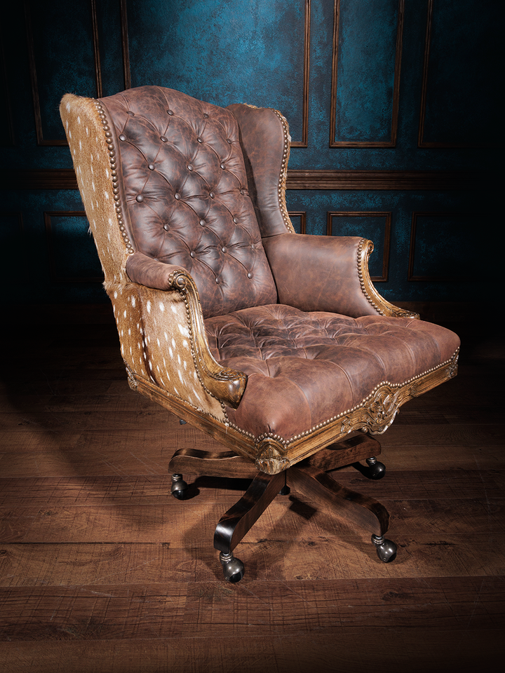 Tufted leather office chair with a high backrest, brown leather upholstery, button tufting, axis hide accents, nailhead trim, and a swivel base with casters.