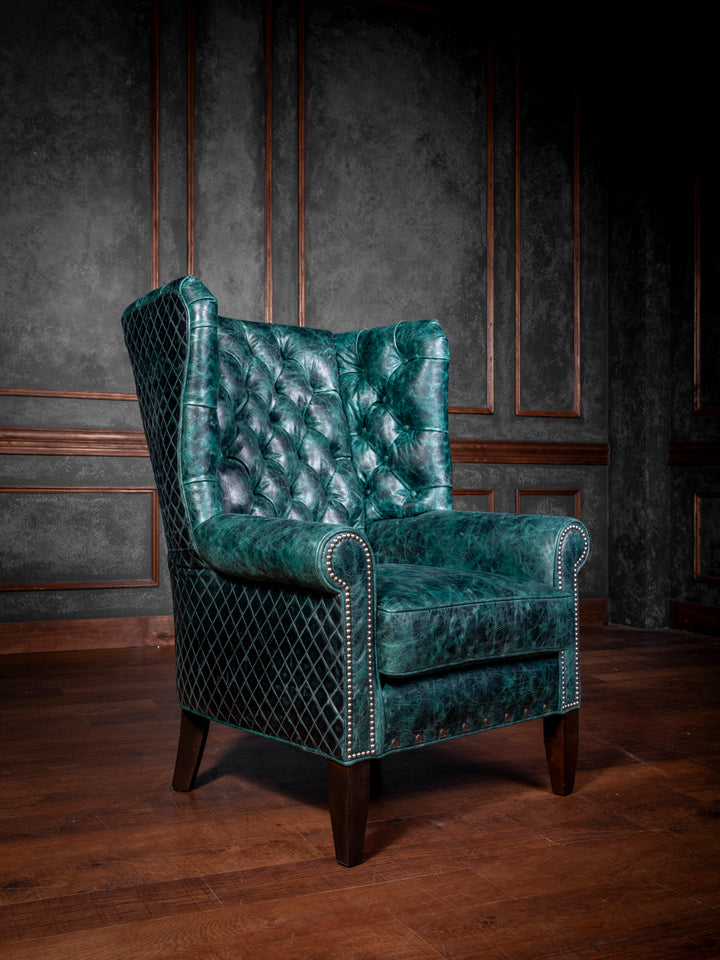 Front view of the Tufted Teal Leather Wingback Chair, showcasing the luxurious full-grain distressed leather, diamond-stitched quilted pattern, and elegant nailhead trim.