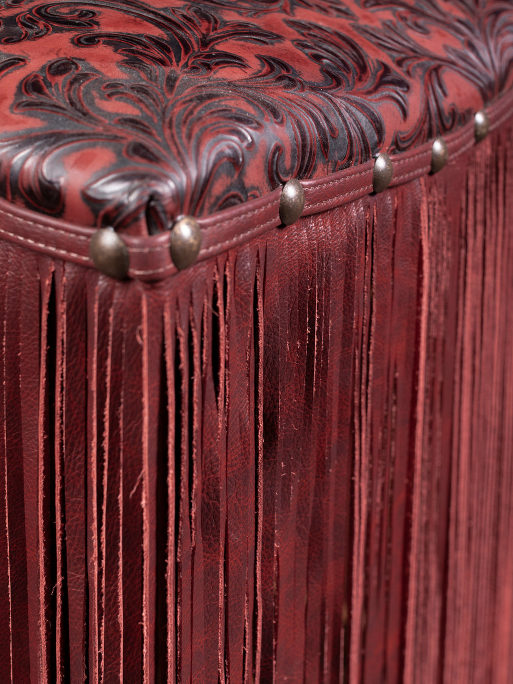 Up close image featuring detailed fringe accent, leather seat pattern, and silver nailheads.