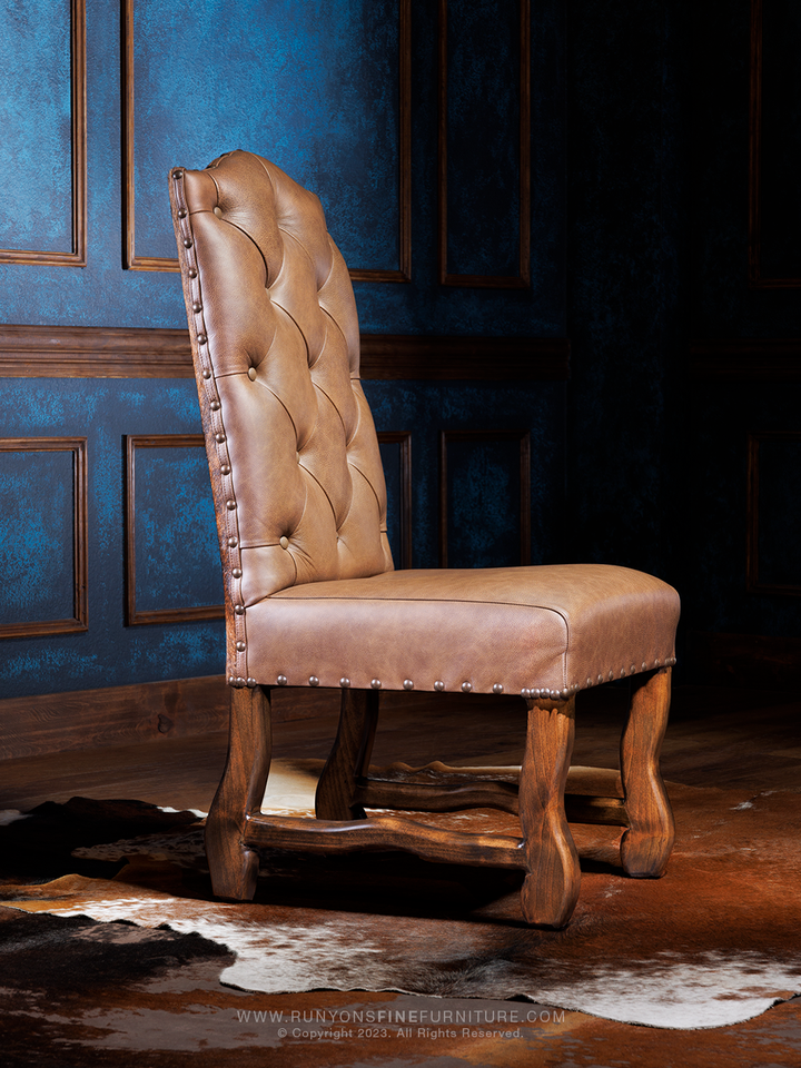 A brown Outback Cowboy Western Cowhide dining chair with a tufted backrest and cowhide upholstery, displayed against an indoor backdrop.