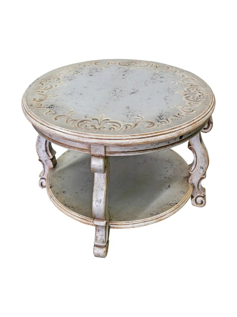 A hand-carved and painted wooden round coffee table with intricate patterns on the tabletop and ornate legs.