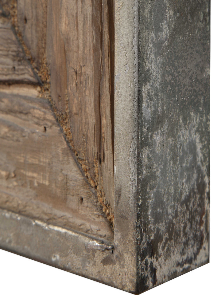 Close-up of a corner where a wooden surface meets a metal frame with a rustic finish.