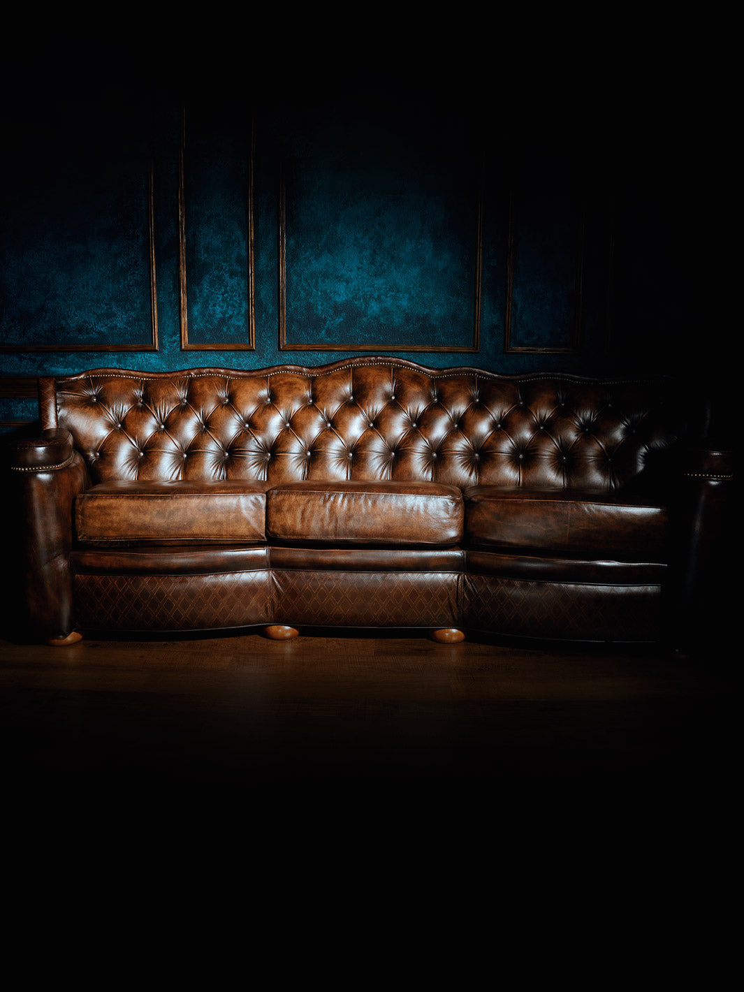 Zoomed out shot of brown tufted leather sofa
