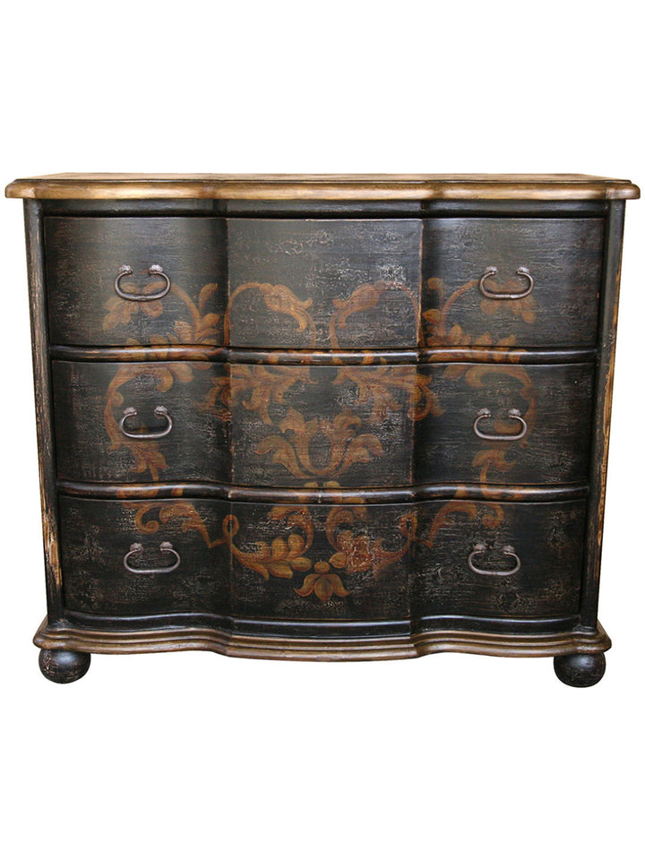A wooden dresser with hand painted floral designs in gold and beige colors on a dark background.