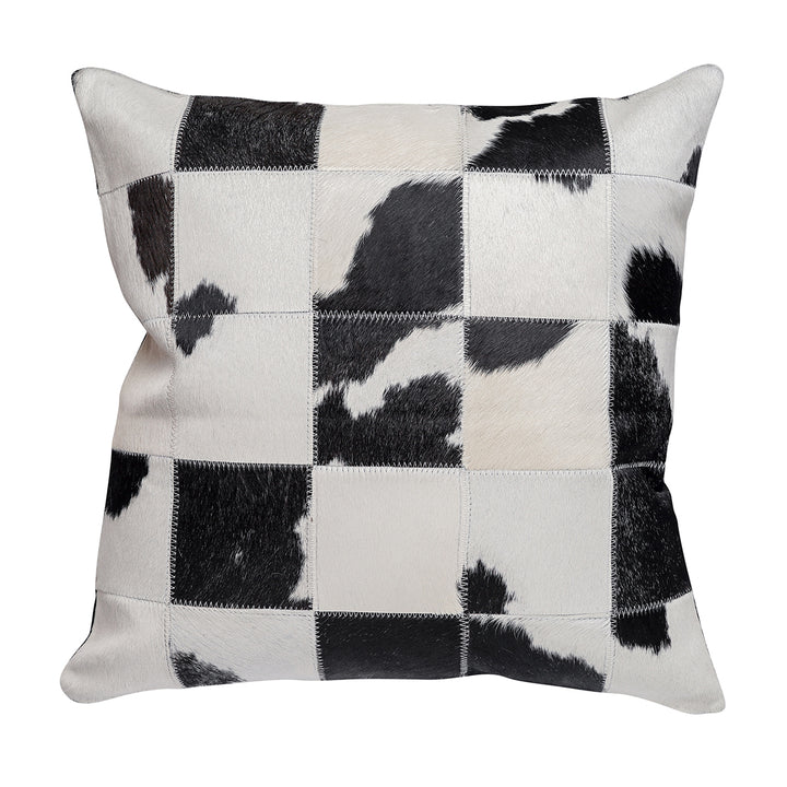 Square throw pillow featuring a black and white hair on hide patchwork design with a grid pattern, showcasing varied textures of black and white squares.