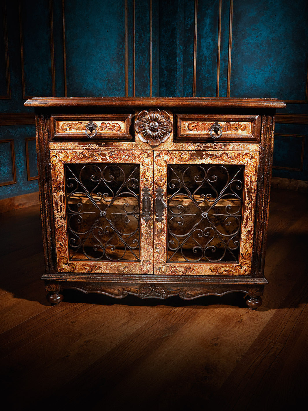 A luxurious wooden chest with intricate metalwork and a speckled brown finish, featuring Peruvian wrought iron hardware.