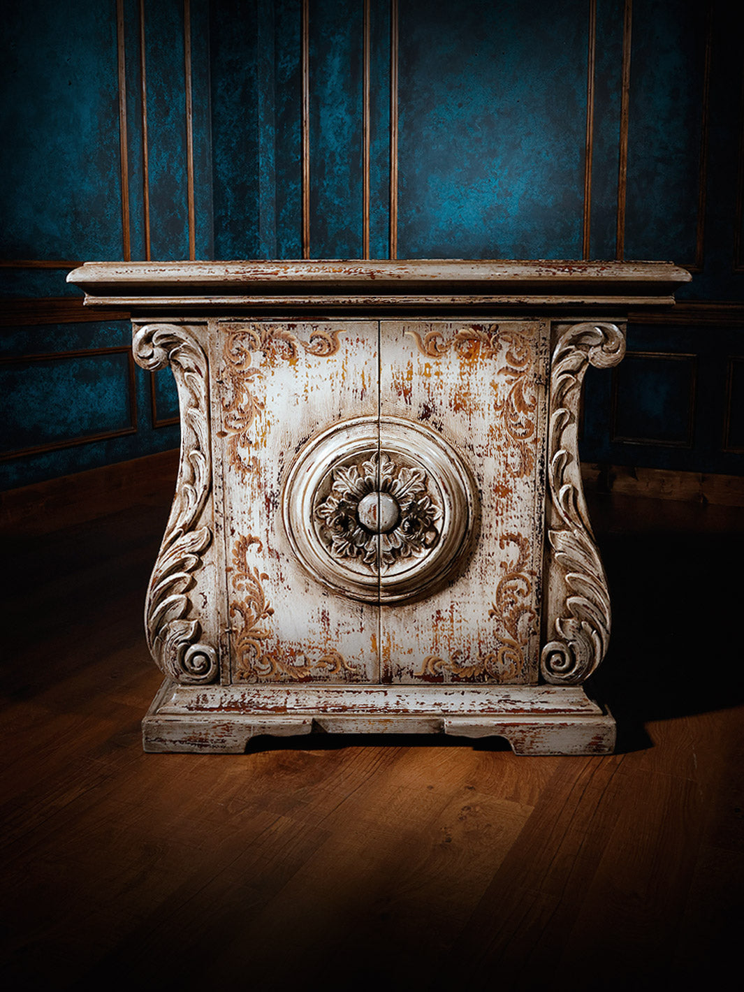 A hand-carved, solid hardwood chest with intricate designs and a distressed white finish, featuring Peruvian wrought iron hardware.