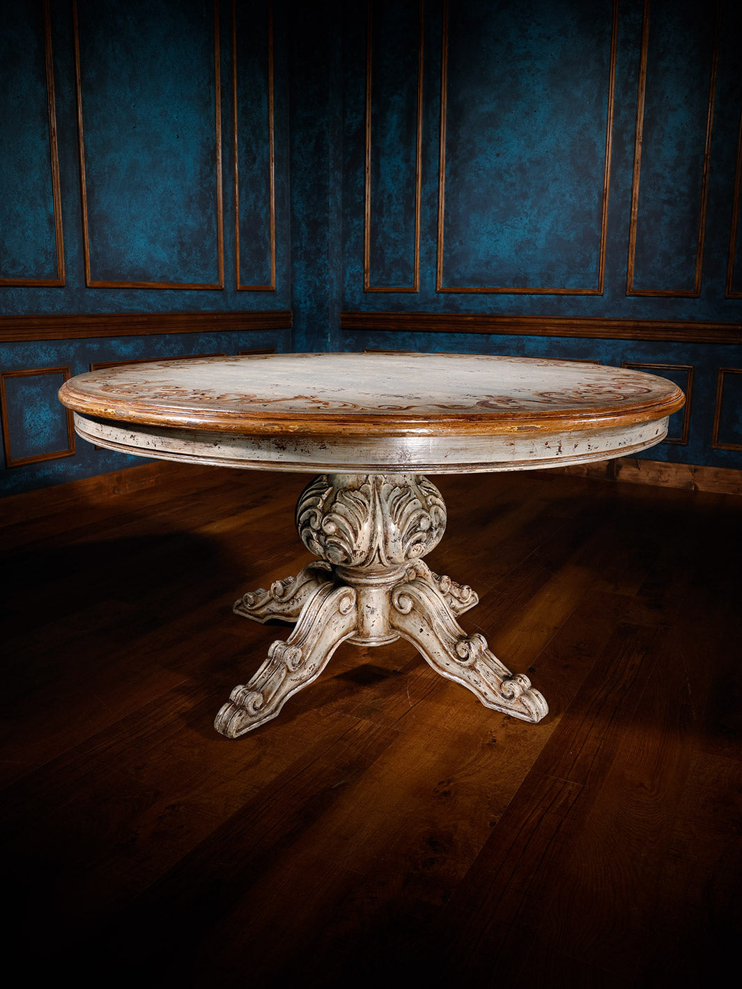 A round dining table with a rustic old world style, featuring hand-painted details and a painted finish.