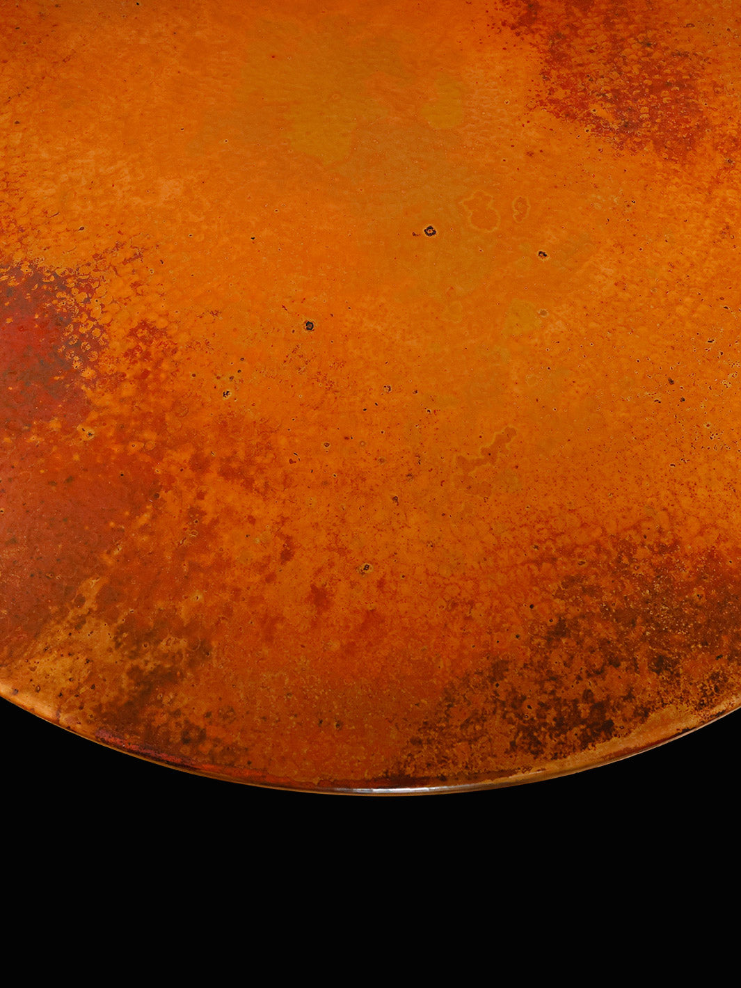 Close-up of the copper tabletop, featuring hand-hammered texture and a natural aged patina with fiery orange and deep bronze tones.