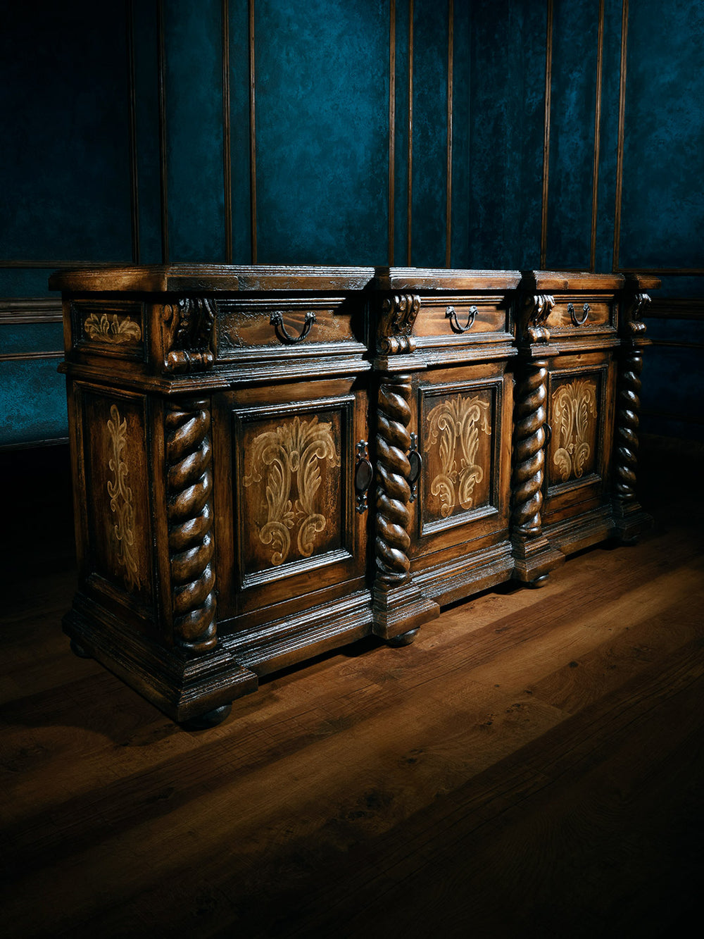 side view of carved wooden buffet with 3 doors